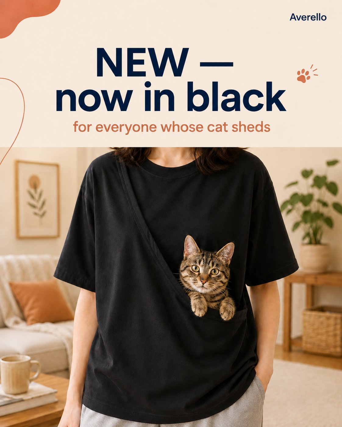 The Cat Carrier Tee in black with a cat in the pouch